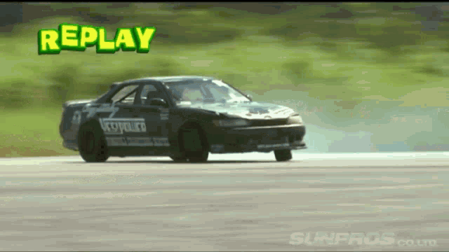 a car is drifting on a track and the word replay is visible above it