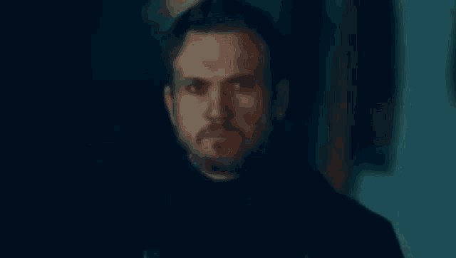 a close up of a man 's face with smoke coming out of his mouth