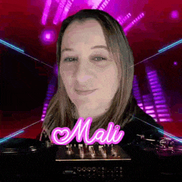 a woman is standing in front of a mixer with the name mali on it