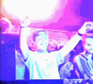 a man with his arms in the air in front of a sign that says ' a ' on it