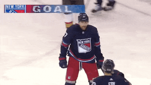 a hockey player for the new york rangers celebrates a goal with his teammate