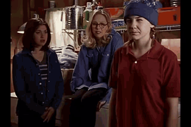 a group of people are standing next to each other in a room in a garage .