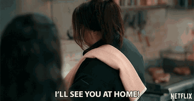 a woman says i 'll see you at home in a kitchen