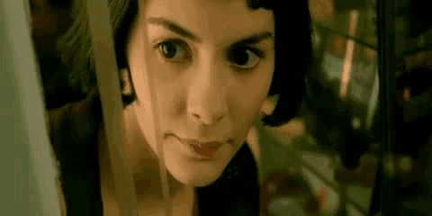 a close up of a woman 's face behind a fence .