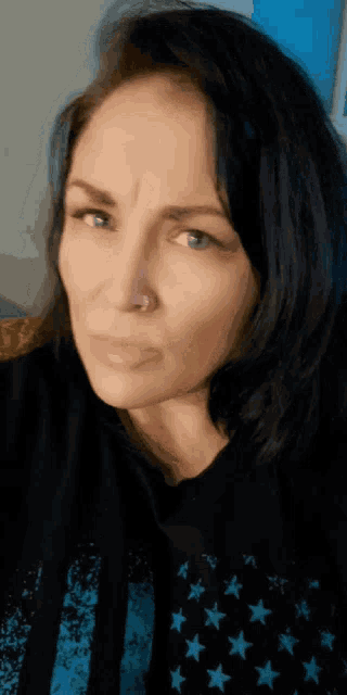 a close up of a woman 's face with a nose ring