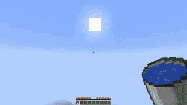 an aerial view of a minecraft world with a green cube in the middle