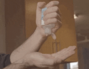 a man is applying hand sanitizer to his hand