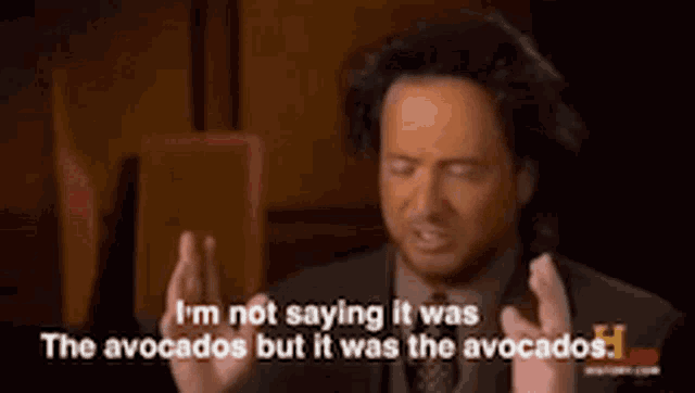 a man in a suit and tie is talking about avocados