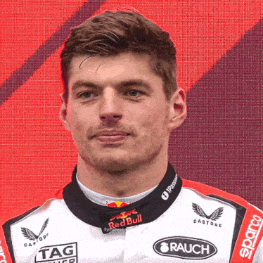 a man wearing a red bull racing uniform