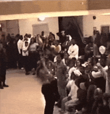 a large group of people are gathered in a room .