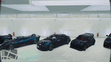 several cars are parked in a garage with a fire extinguisher on the wall behind them