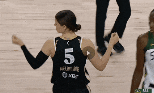 a female basketball player wearing a jersey that says melbourne on it