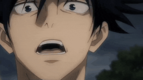 a close up of a person 's face with a surprised look on their face .