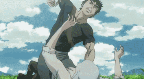 a man in a black shirt is fighting another man in a field .