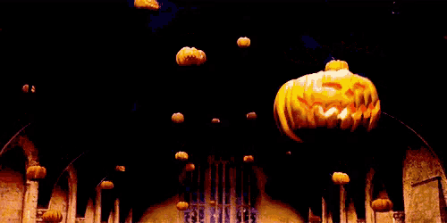 a bunch of pumpkins are hanging from the ceiling