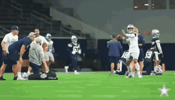 a group of football players are on a field with one wearing number 19