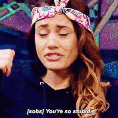 a woman wearing a headband is saying sobs you 're so stupid