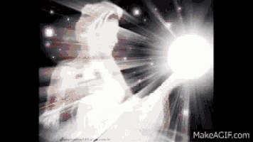 a woman in a white dress is holding a white light in her hands .