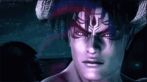 a close up of a demon with horns on his face .