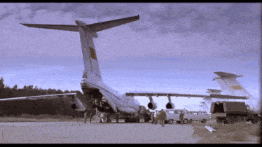 a large airplane with a cccp logo on the tail is on a runway