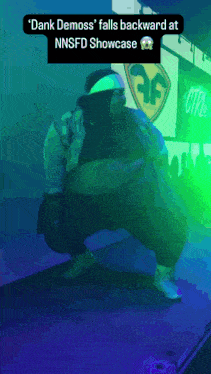 dank demoss falls backward at nnsfd showcase with a purple background