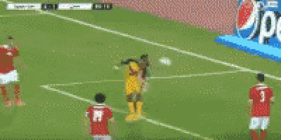 a blurry picture of a soccer game with a sign in the background that says ' coca cola '