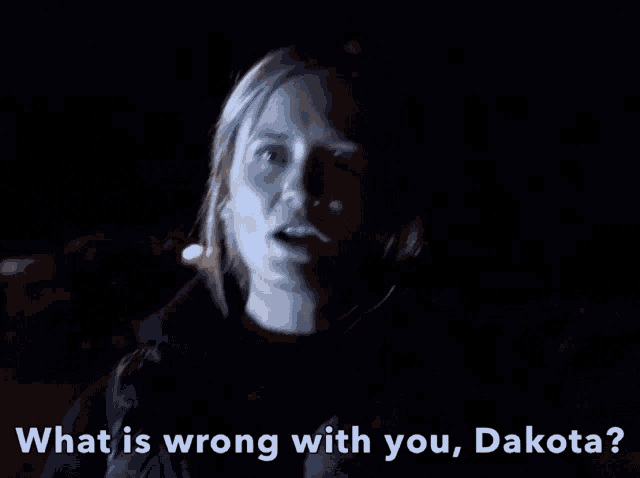 a blurry picture of a woman with the words " what is wrong with you dakota "