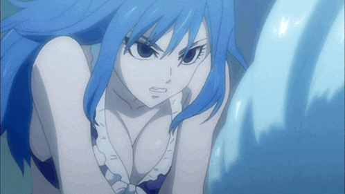 a girl with blue hair and a plunging neckline looks at the camera