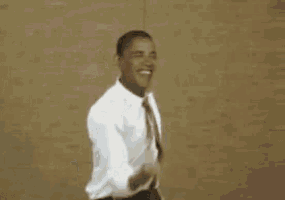 a man in a white shirt and red tie is dancing and smiling .
