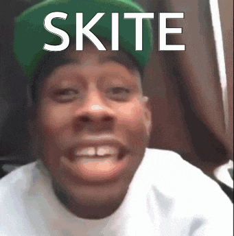a man wearing a green hat and a white shirt with the word skite on it