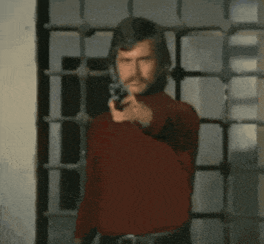 a man with a mustache wearing a red sweater