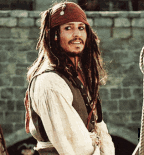jack sparrow from pirates of the caribbean is smiling and looking at the camera