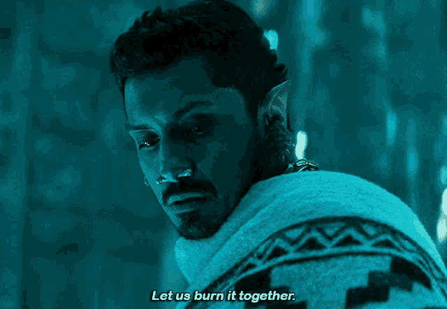 a man with a nose ring and ear piercing says let us burn it together
