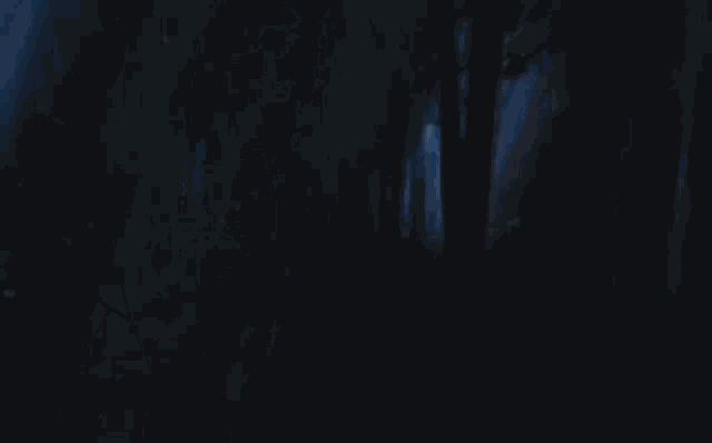 a close up of a person 's face with a sword in his hand and a blue background .