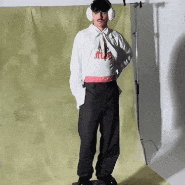 a man wearing ear protectors and a shirt that says stop
