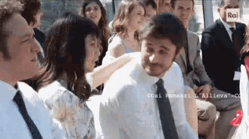 a man in a white shirt and tie is standing next to a woman in a white dress ..