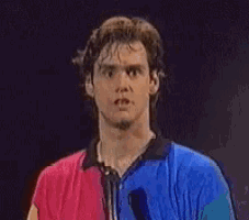 a man wearing a blue and red shirt is looking at the camera
