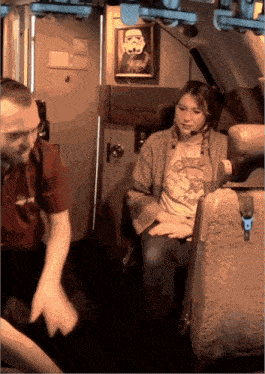 a woman in a storm trooper shirt sits next to a man in a star wars shirt