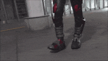 a person in a superhero costume is walking down a sidewalk