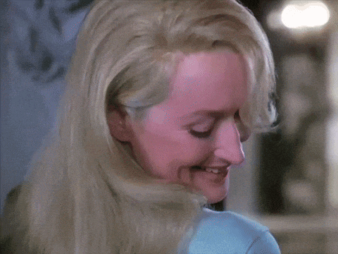 a close up of a woman 's face with long blonde hair .