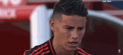 a close up of a soccer player 's face with the word usa on the bottom right