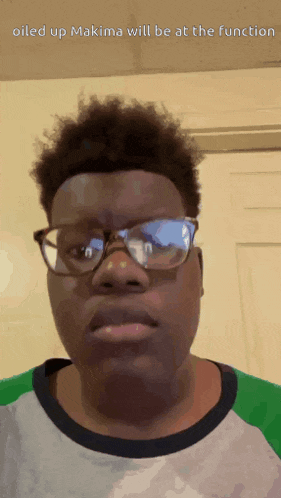 a young man wearing glasses and a shirt with the words oiled up makima will be at the function