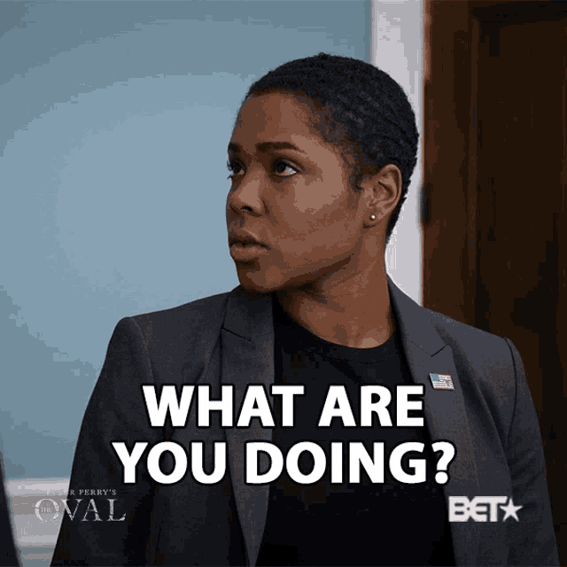 a woman in a suit says " what are you doing " in white letters