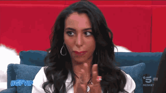 a woman sitting on a couch with the hashtag #gfvip on the bottom right