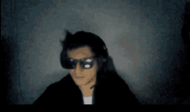 a blurry picture of a man wearing goggles and headphones
