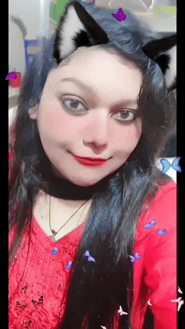 a woman wearing cat ears and a red shirt is surrounded by butterflies