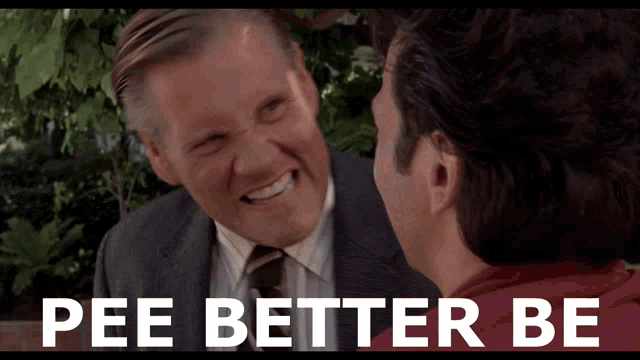 a man in a suit and tie is smiling next to another man with the words pee better be below him