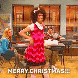 a girl in a pink dress is dancing in a classroom with the words merry christmas written on the bottom