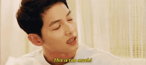 a young man is sitting on a bed with his eyes closed and says `` this is too much ! ''