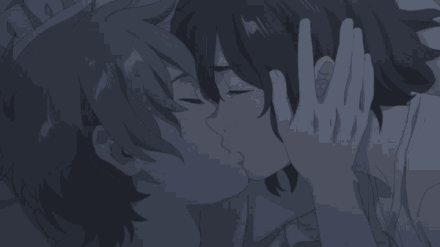 a man and a woman are kissing in a dark room
